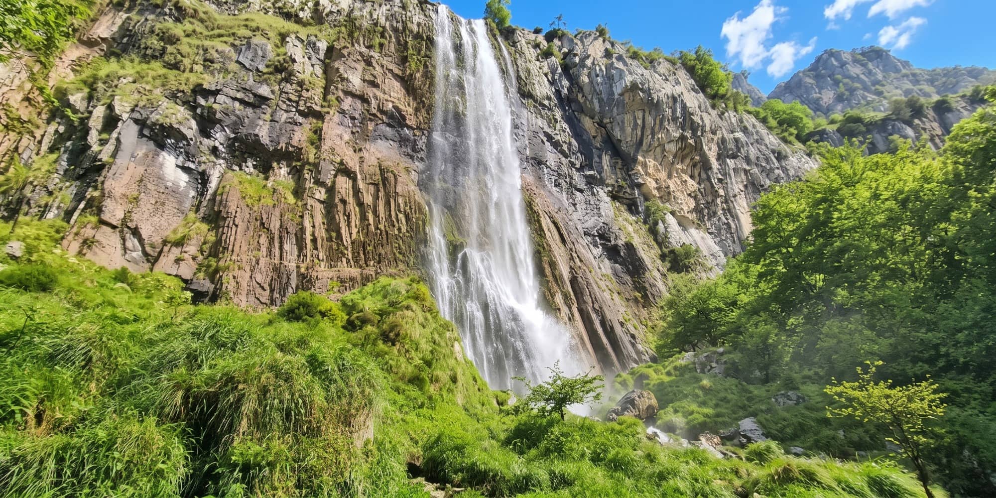 Waterfall at the source of the Asón river in the Collados del Asón with water in the foreground