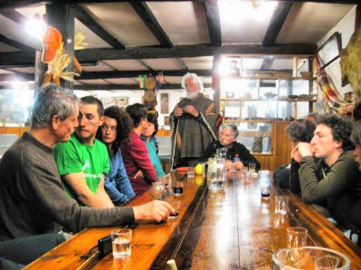 Communal table at the Güemes hostel during dinner, with pilgrims gathered and warm indoor light
