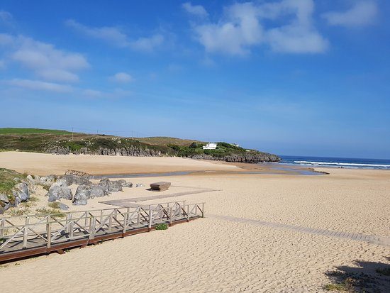 General view of Playa de Ajo (Cuberris) at low tide with golden sand, on a sunny day
