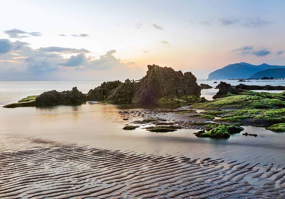 Panoramic view of Trengandín beach in Noja at low tide, golden sand and the Cantabrian Sea in the background