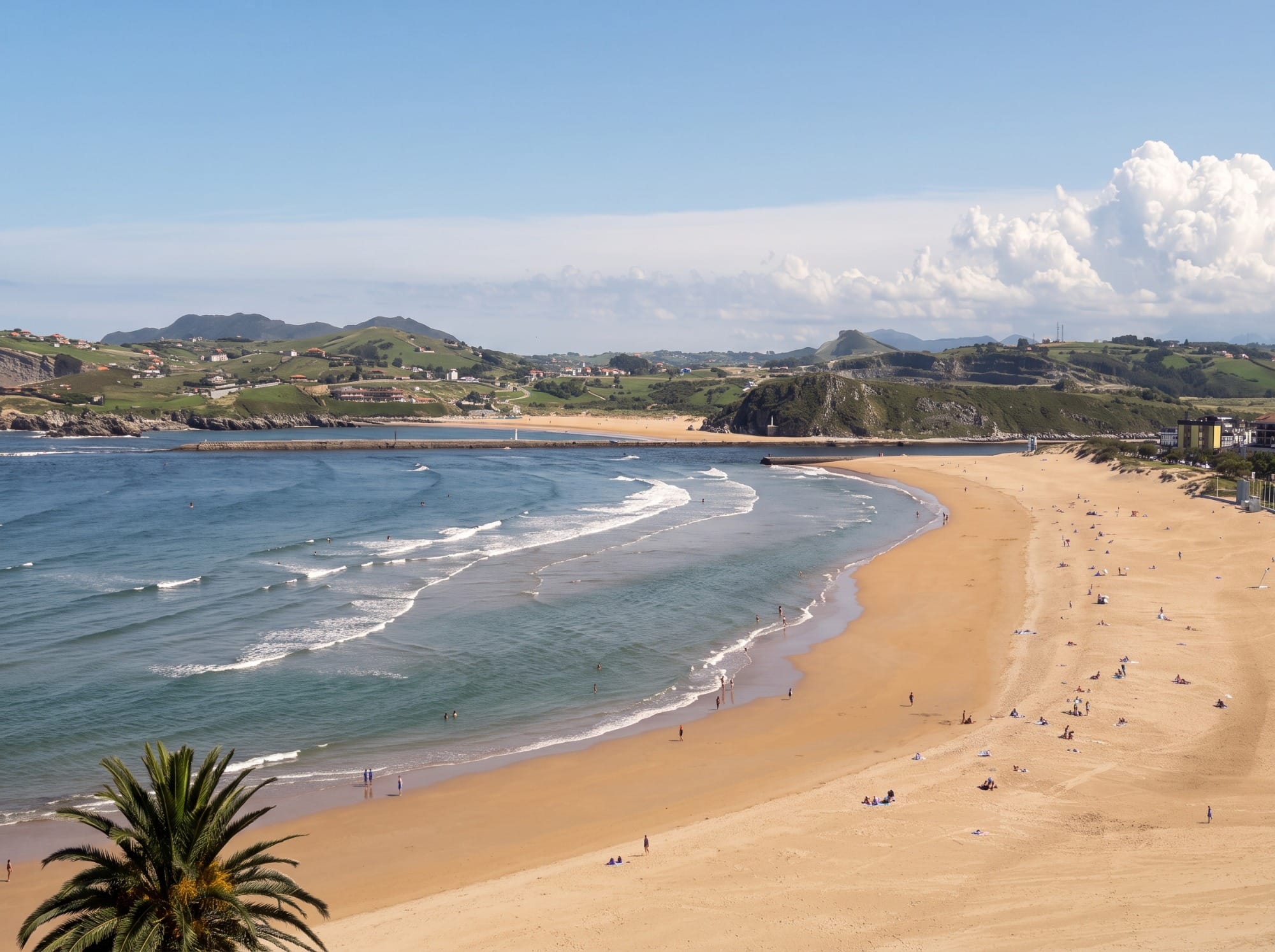 La Concha beach in Suances with the promenade in the background, afternoon light