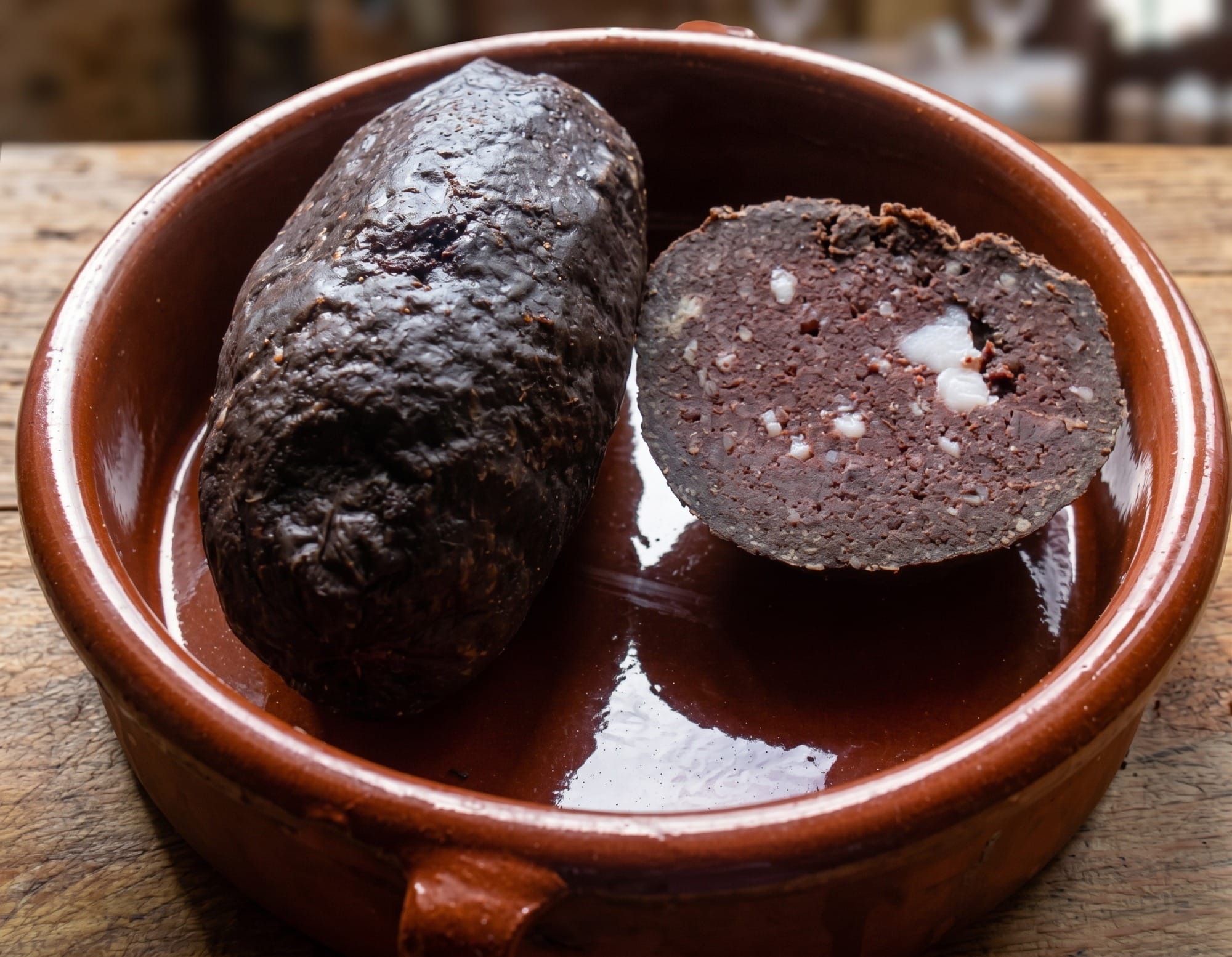 Whole boiled borono on a wooden board next to onion and corn flour