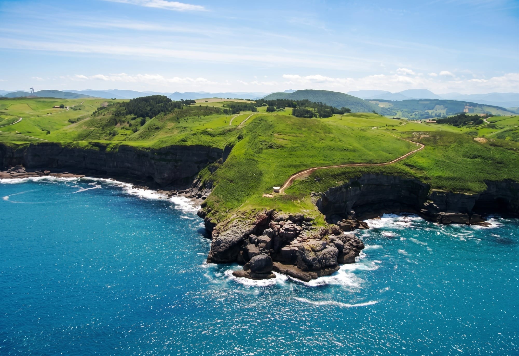 General view of the Trasmiera coast from a viewpoint, with the Cantabrian Sea and the Bareyo cliffs