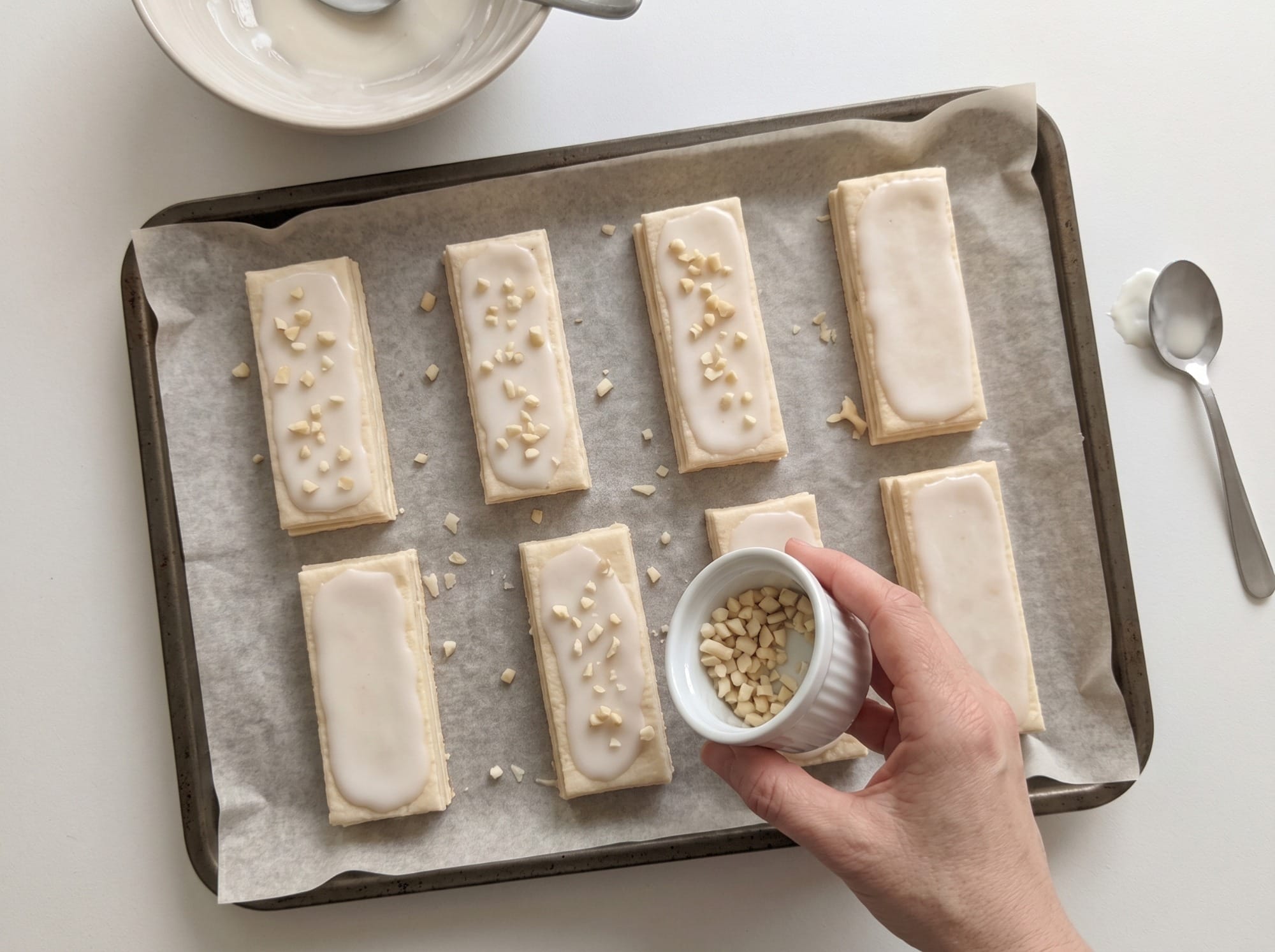 Close-up of several iced puff pastry polkas on a tray